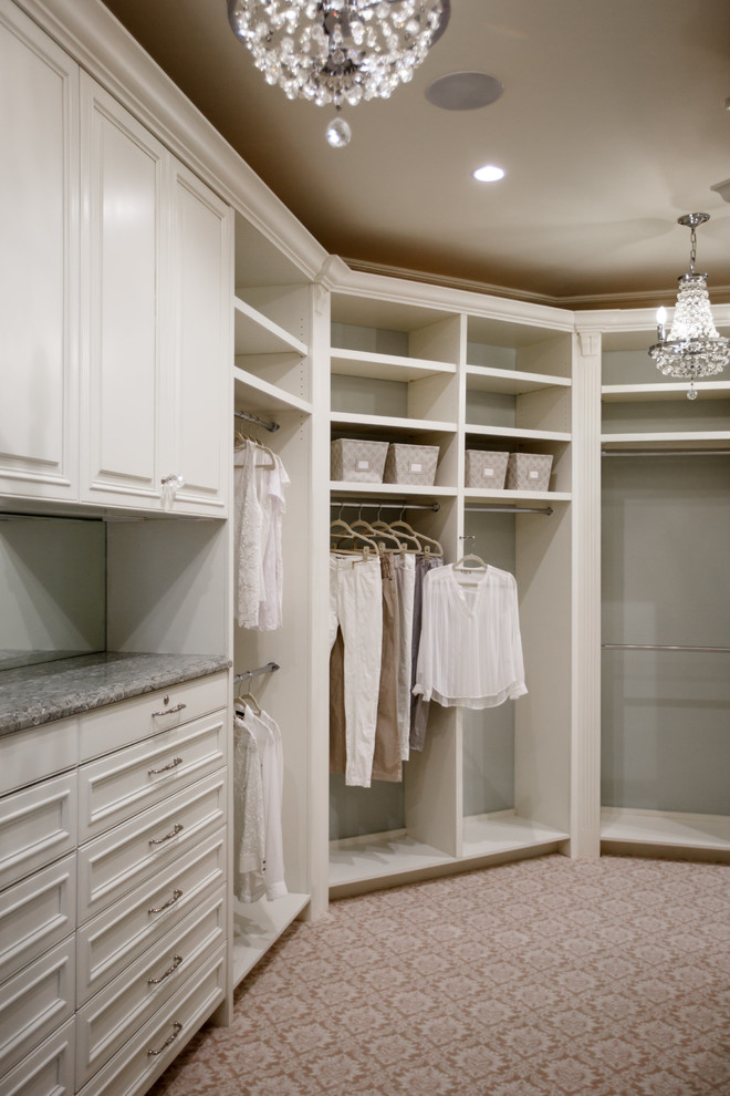 This is an example of a large classic gender neutral dressing room in Jacksonville with recessed-panel cabinets, white cabinets and carpet.