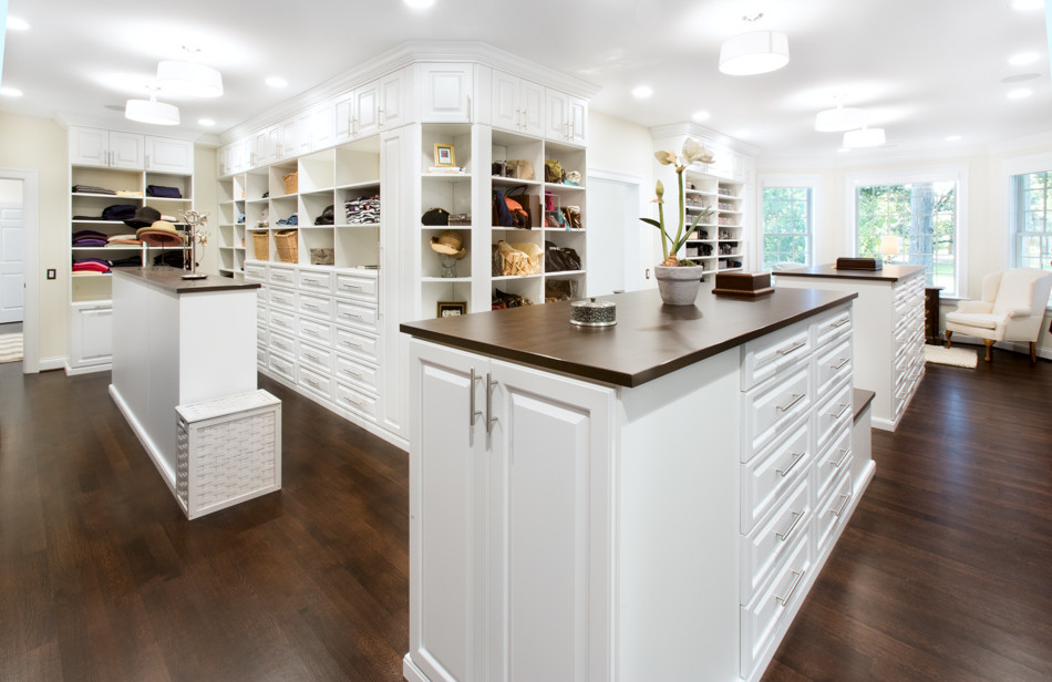 Inspiration for a huge timeless gender-neutral dark wood floor dressing room remodel in Chicago with raised-panel cabinets and white cabinets