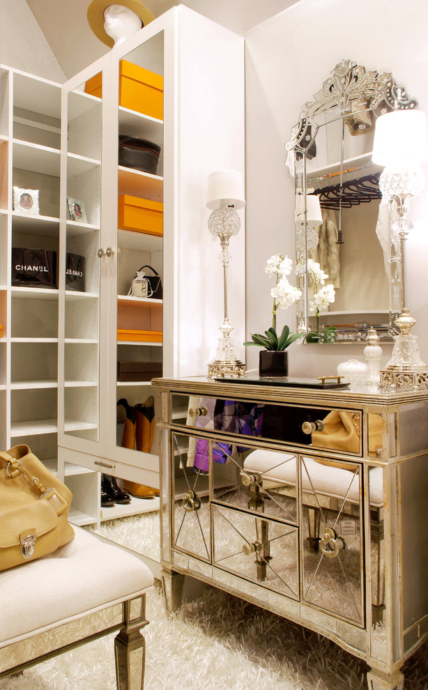 Inspiration for a mid-sized eclectic women's carpeted dressing room remodel in New York with flat-panel cabinets and white cabinets