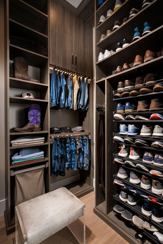 Medium sized modern walk-in wardrobe for men in Other with flat-panel cabinets, medium wood cabinets, light hardwood flooring and brown floors.