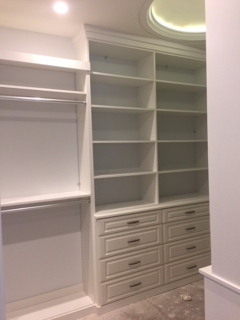 Photo of a medium sized contemporary walk-in wardrobe for women in Orlando with raised-panel cabinets, white cabinets and carpet.