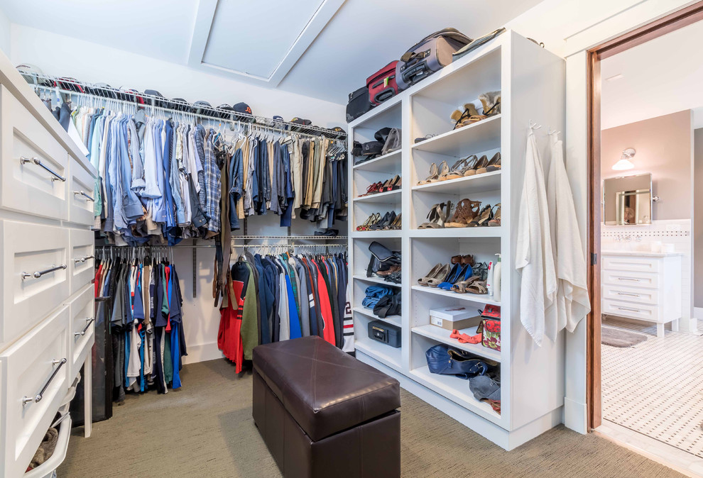 This is an example of a medium sized classic gender neutral walk-in wardrobe in Chicago with shaker cabinets, white cabinets, carpet, beige floors, feature lighting and a wallpapered ceiling.