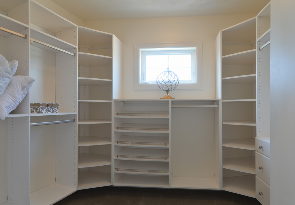 Design ideas for a small traditional gender neutral walk-in wardrobe in New York with flat-panel cabinets, white cabinets and carpet.