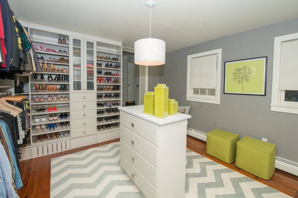 Photo of a large contemporary dressing room for women in Philadelphia with white cabinets, light hardwood flooring and open cabinets.