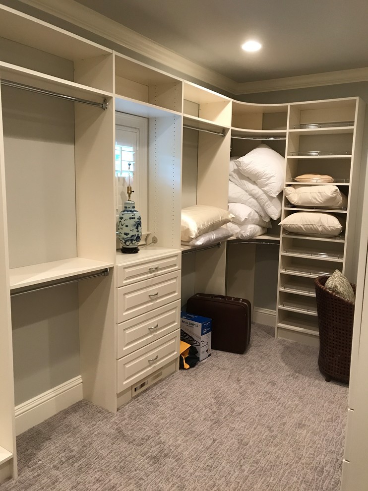 Example of a large classic gender-neutral carpeted and gray floor walk-in closet design in Huntington with raised-panel cabinets and white cabinets
