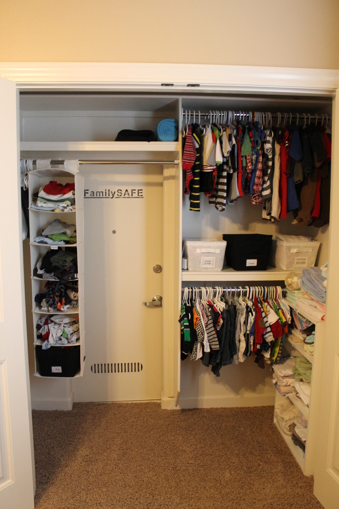Example of a mid-sized classic gender-neutral carpeted and brown floor walk-in closet design in Little Rock with open cabinets and white cabinets
