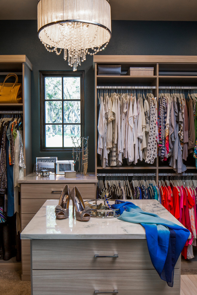 Inspiration for a large transitional women's carpeted dressing room remodel in Austin with open cabinets and light wood cabinets