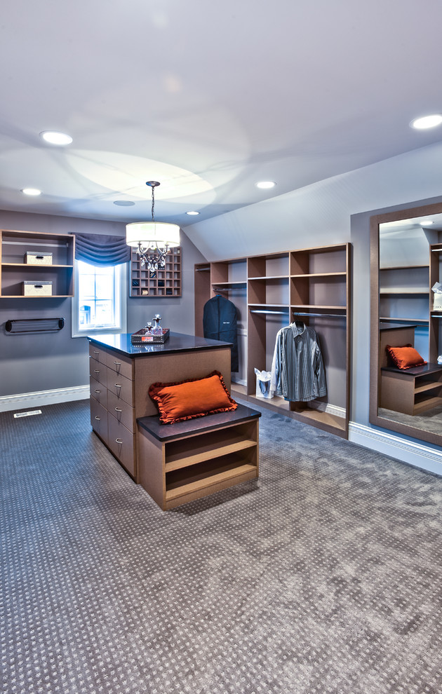 Design ideas for an expansive classic gender neutral dressing room in Chicago with carpet, flat-panel cabinets, beige cabinets and beige floors.