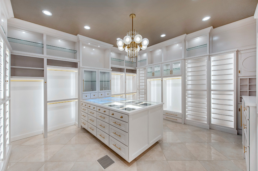 Large trendy women's marble floor walk-in closet photo in Oklahoma City with shaker cabinets and white cabinets