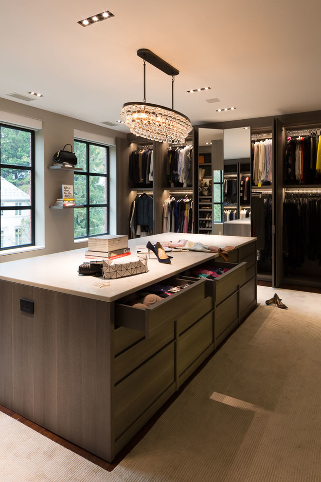 Example of a huge trendy women's carpeted and beige floor walk-in closet design in DC Metro with flat-panel cabinets and medium tone wood cabinets