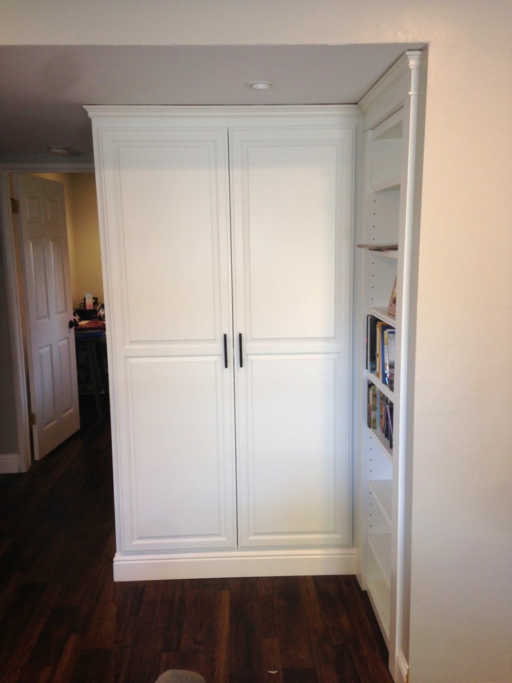 Photo of a medium sized classic gender neutral walk-in wardrobe in Sacramento with raised-panel cabinets, white cabinets and medium hardwood flooring.