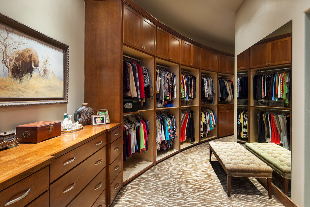 Inspiration for a traditional dressing room in Austin with open cabinets and dark wood cabinets.