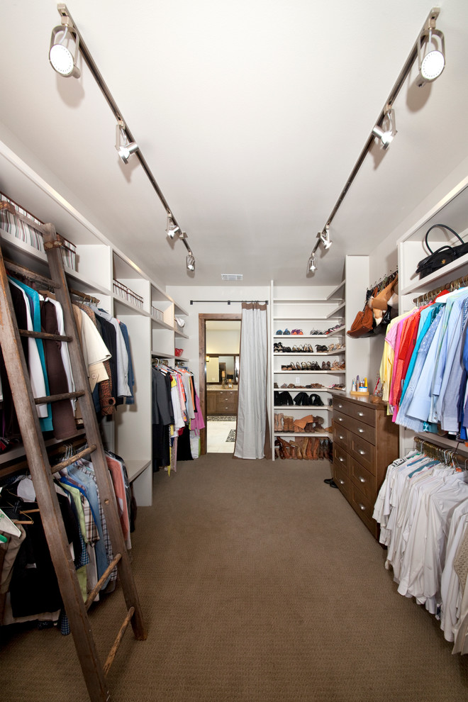 Inspiration for a large gender-neutral carpeted walk-in closet remodel in Austin with shaker cabinets and medium tone wood cabinets