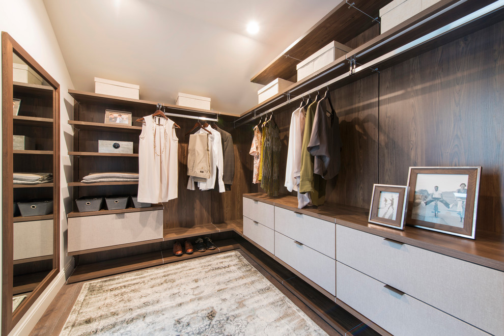 Inspiration for a contemporary walk-in wardrobe in San Francisco with flat-panel cabinets, medium wood cabinets, medium hardwood flooring and brown floors.
