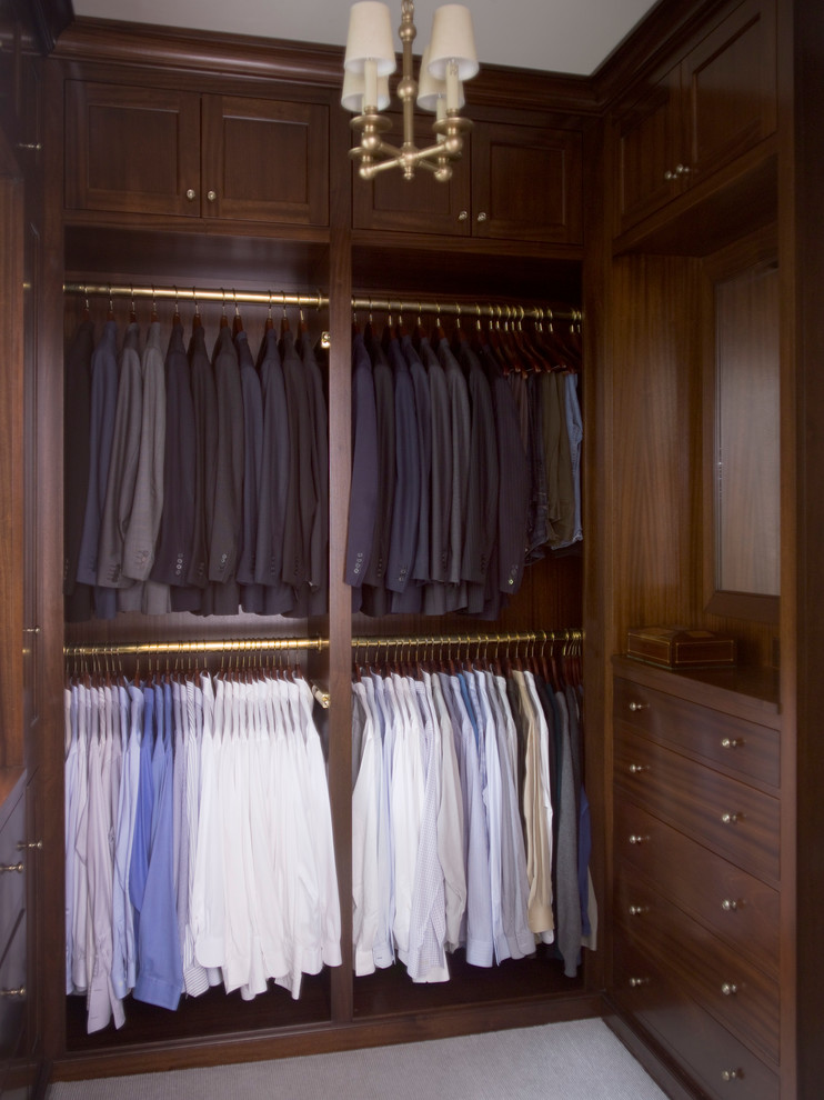 Large elegant men's walk-in closet photo in Atlanta with dark wood cabinets