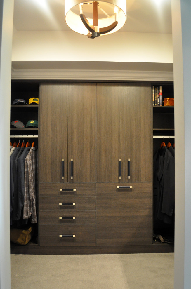 Пример оригинального дизайна: гардеробная комната среднего размера в стиле неоклассика (современная классика) с плоскими фасадами, ковровым покрытием и коричневыми фасадами для мужчин