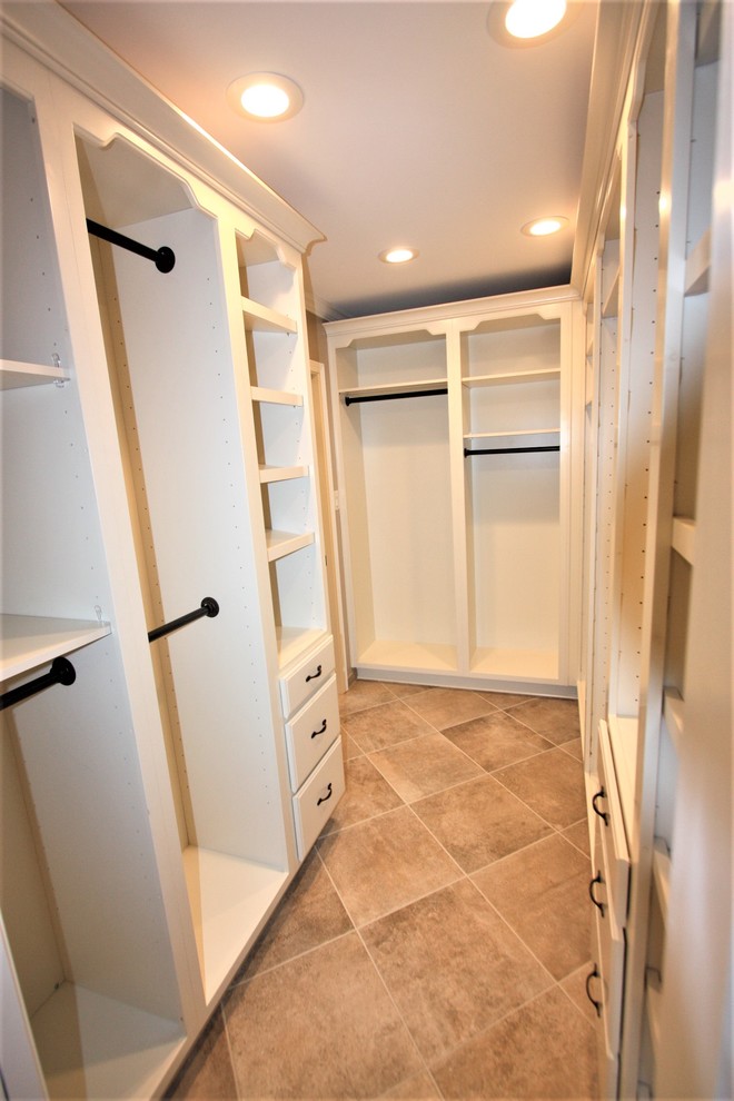 Design ideas for a large classic wardrobe in Other with raised-panel cabinets, white cabinets and porcelain flooring.