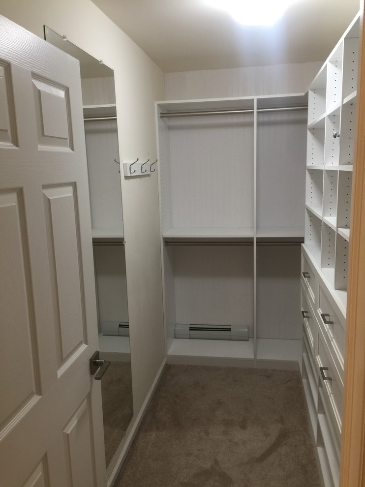 Small transitional gender-neutral walk-in closet photo in New York
