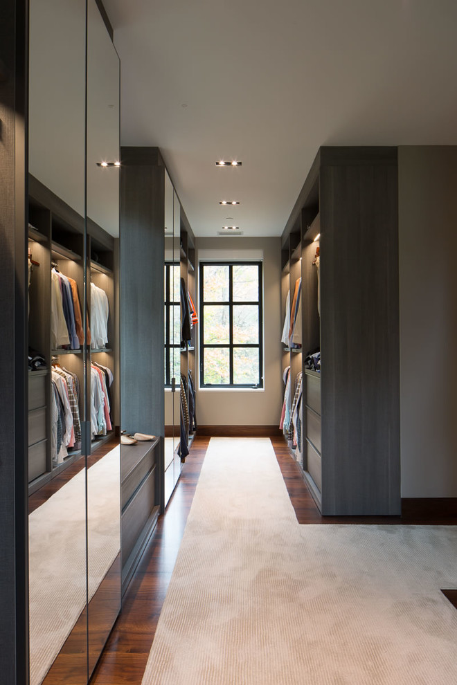 На фото: огромная гардеробная комната в современном стиле с плоскими фасадами, ковровым покрытием, бежевым полом и серыми фасадами для мужчин с