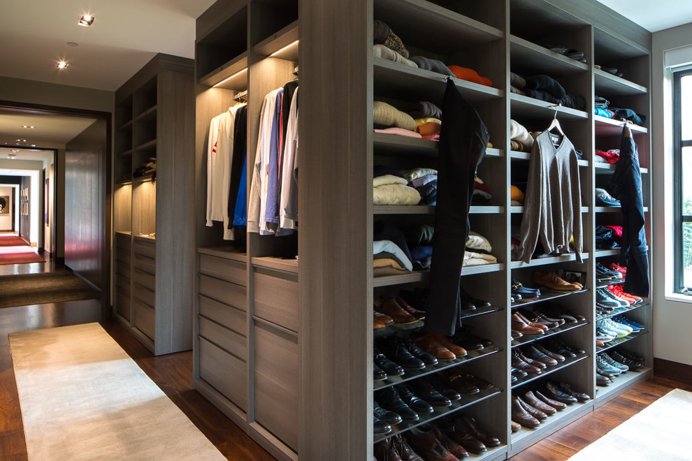 Walk-in closet - huge contemporary men's carpeted and beige floor walk-in closet idea in DC Metro with flat-panel cabinets and medium tone wood cabinets