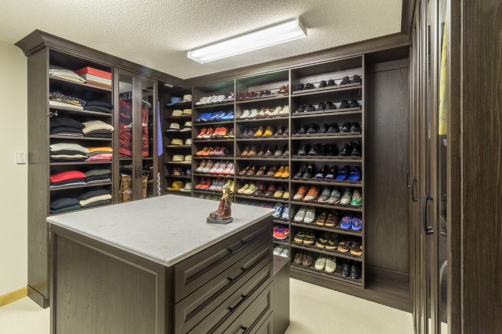 Walk-in closet - large contemporary men's carpeted walk-in closet idea in Minneapolis with recessed-panel cabinets and dark wood cabinets
