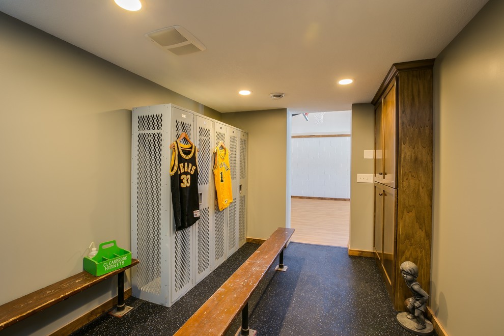 Example of a large transitional men's cork floor walk-in closet design in Minneapolis with recessed-panel cabinets and dark wood cabinets