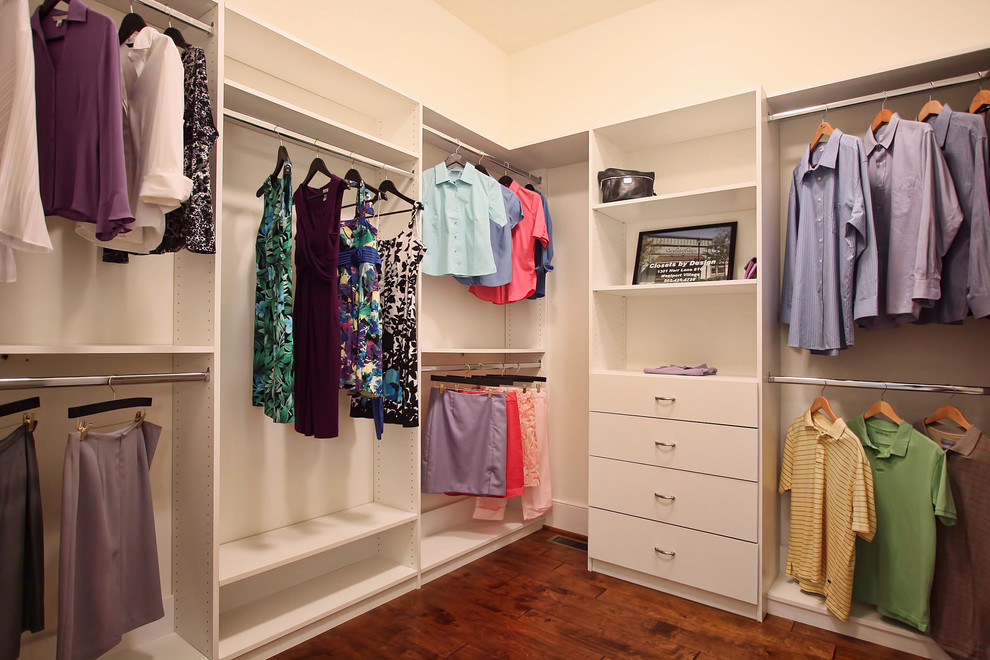 Example of a large classic gender-neutral medium tone wood floor walk-in closet design in Louisville with flat-panel cabinets and white cabinets