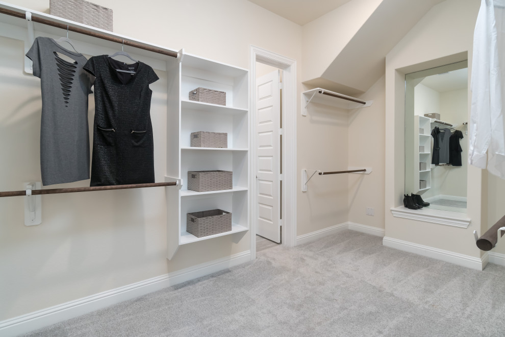 Large trendy carpeted and gray floor walk-in closet photo in Houston