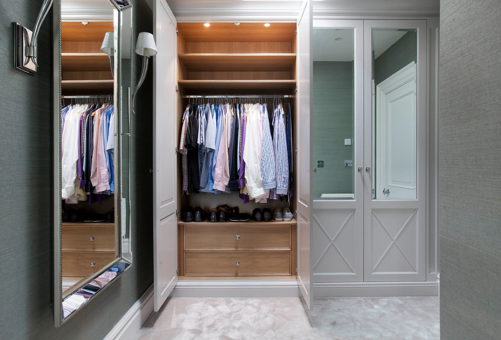 Photo of a classic gender neutral dressing room in Dublin with recessed-panel cabinets, grey cabinets, carpet and beige floors.