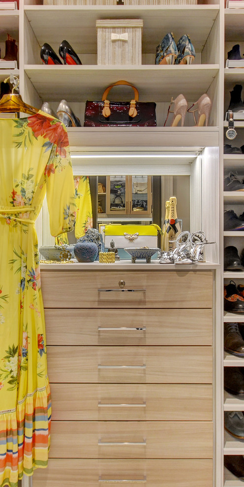 Mid-sized trendy women's carpeted and beige floor walk-in closet photo in Miami with flat-panel cabinets and light wood cabinets
