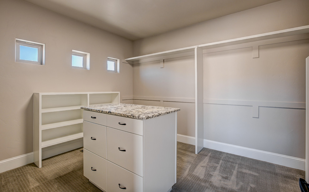 Example of a large transitional gender-neutral carpeted dressing room design in Denver with flat-panel cabinets and white cabinets