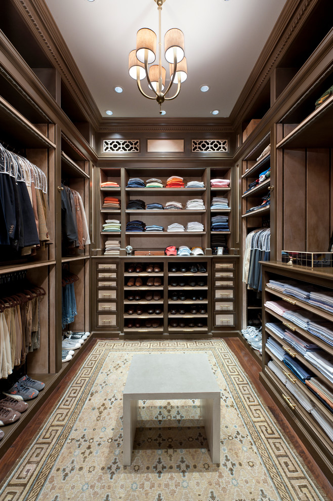 This is an example of a large traditional walk-in wardrobe for men in Miami with open cabinets, dark wood cabinets and dark hardwood flooring.