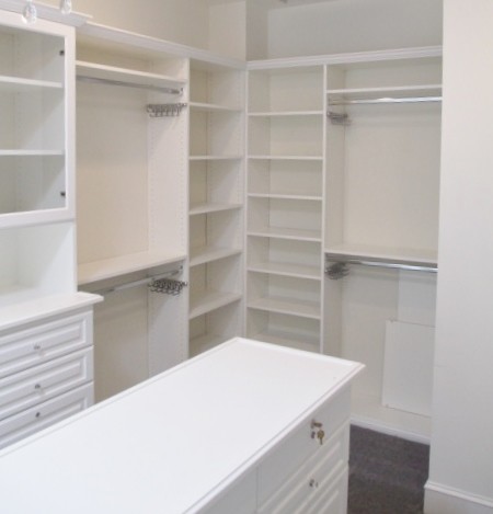 Example of a large classic gender-neutral carpeted and gray floor walk-in closet design in Los Angeles with raised-panel cabinets and white cabinets