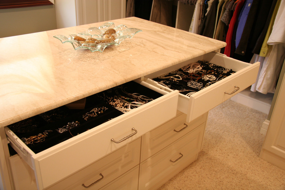 Inspiration for a large timeless gender-neutral carpeted dressing room remodel in Chicago with white cabinets