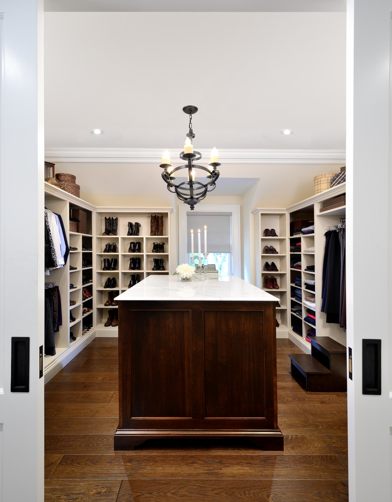 Example of an arts and crafts women's medium tone wood floor walk-in closet design in Toronto with open cabinets and white cabinets