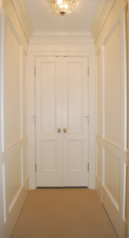 Diseño de armario vestidor tradicional de tamaño medio con puertas de armario blancas, moqueta y armarios con paneles empotrados