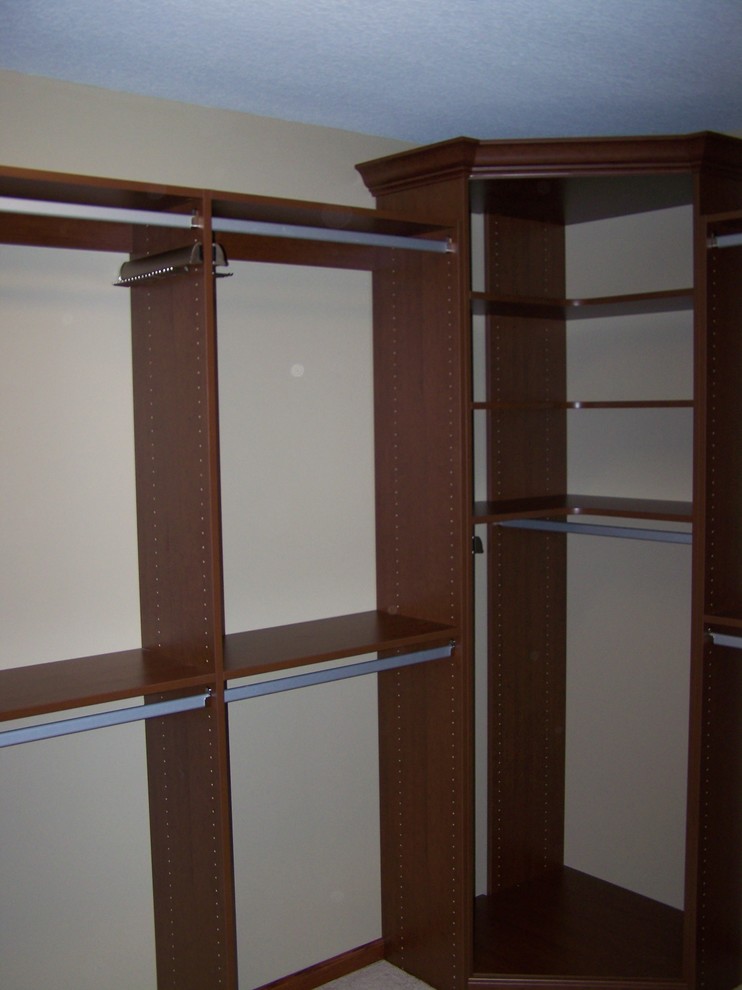 Inspiration for a large traditional gender neutral walk-in wardrobe in Other with flat-panel cabinets.