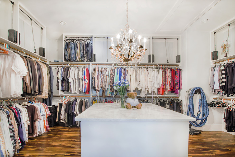 Example of a transitional gender-neutral medium tone wood floor dressing room design in Austin with open cabinets and white cabinets