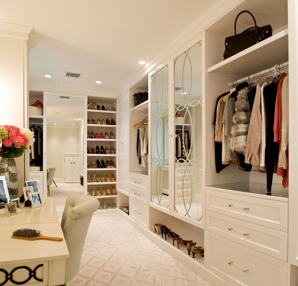 Large traditional gender neutral dressing room in DC Metro with recessed-panel cabinets, white cabinets, carpet and beige floors.