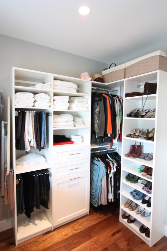 Walk-in closet - large transitional gender-neutral medium tone wood floor walk-in closet idea in Vancouver with shaker cabinets and white cabinets