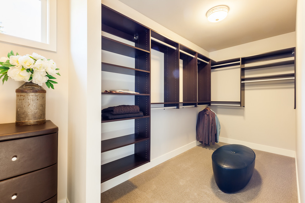 Inspiration for a medium sized modern gender neutral walk-in wardrobe in Seattle with open cabinets, dark wood cabinets and carpet.