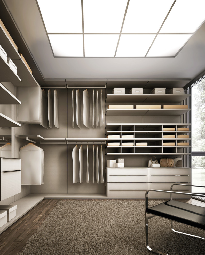 Inspiration for a large modern gender neutral walk-in wardrobe in Los Angeles with flat-panel cabinets, white cabinets and dark hardwood flooring.