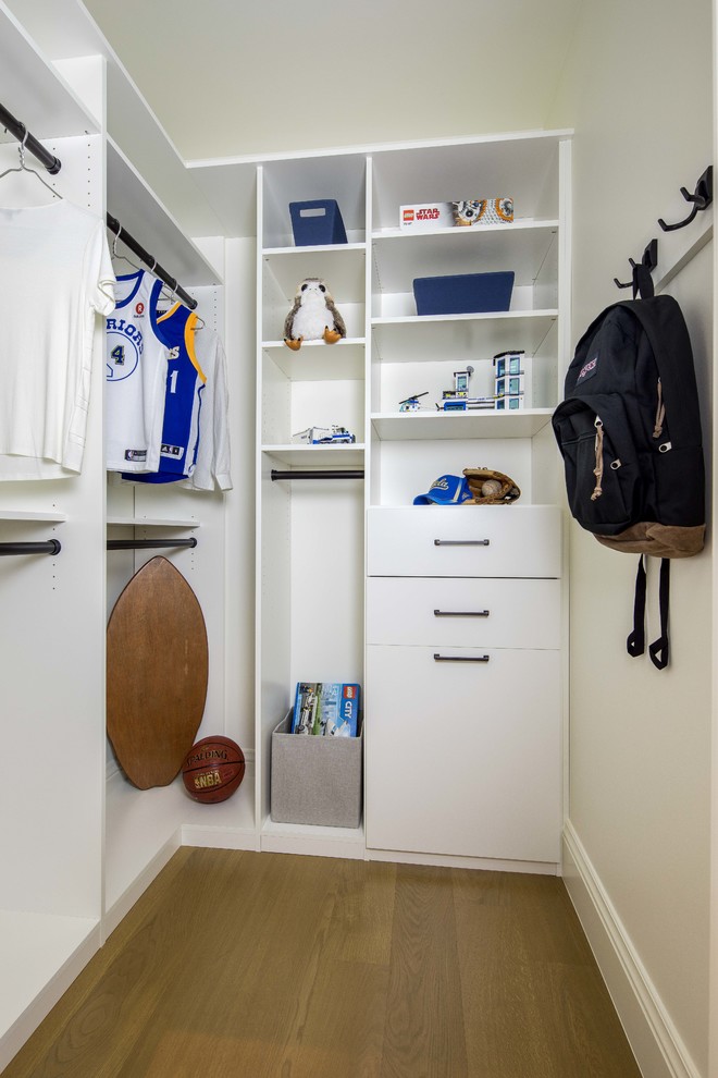 Mid-sized trendy gender-neutral medium tone wood floor and brown floor walk-in closet photo in San Francisco with open cabinets and white cabinets