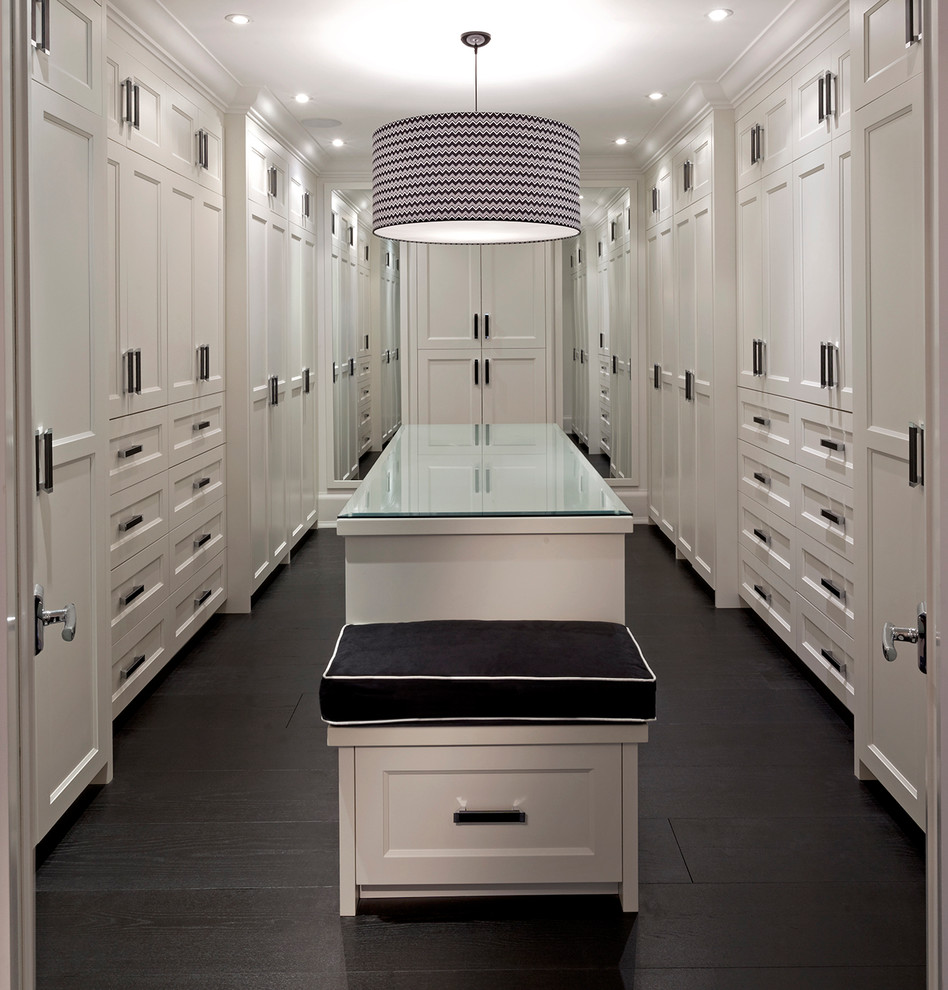 Design ideas for an expansive contemporary gender neutral dressing room in Toronto with recessed-panel cabinets, white cabinets and dark hardwood flooring.