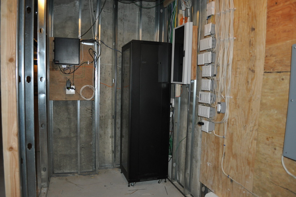 This is an example of a small classic walk-in wardrobe in New York with concrete flooring.