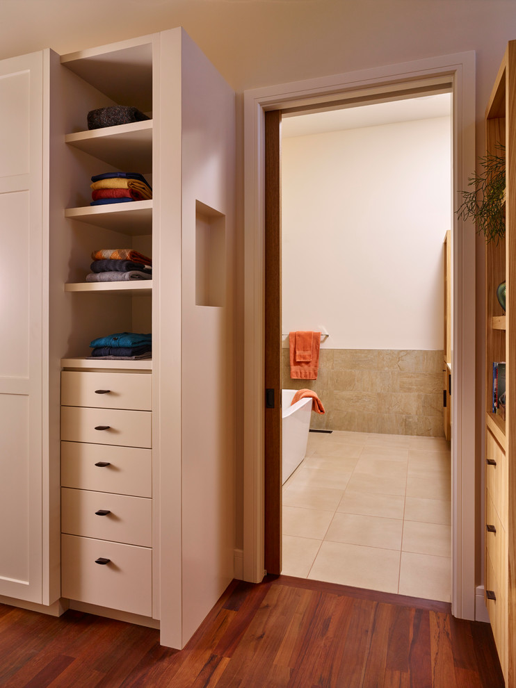Example of a large arts and crafts men's dark wood floor dressing room design in Calgary with shaker cabinets and white cabinets