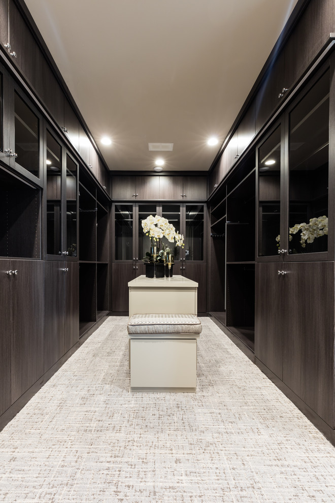 Walk-in closet - huge transitional gender-neutral carpeted and gray floor walk-in closet idea in Dallas with flat-panel cabinets and dark wood cabinets