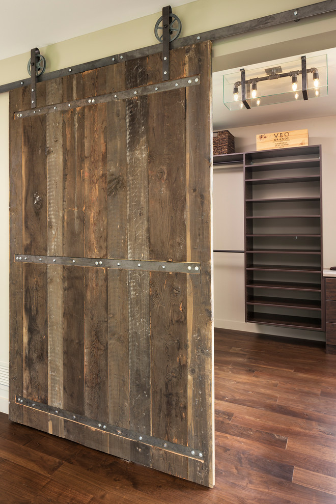 Foto de armario vestidor unisex minimalista pequeño con puertas de armario de madera en tonos medios y suelo de madera en tonos medios