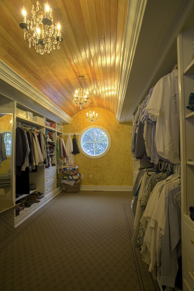 Example of a large arts and crafts gender-neutral carpeted walk-in closet design in Other with shaker cabinets and white cabinets
