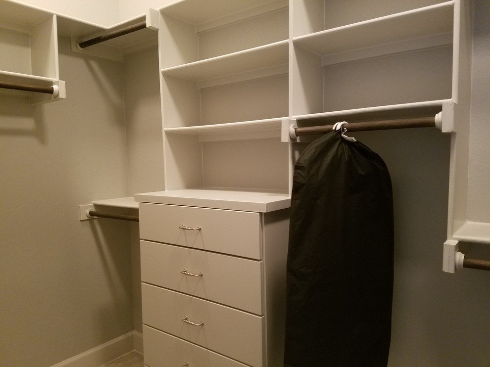 Photo of a medium sized classic gender neutral walk-in wardrobe in Austin with flat-panel cabinets, white cabinets and porcelain flooring.